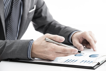 man hand with business report on tableの写真素材