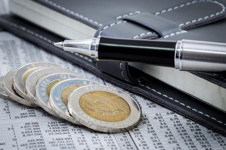 financial report with coins and penの写真素材