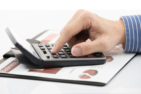 Male hand with pen analyzing financial data. Accountingの写真素材