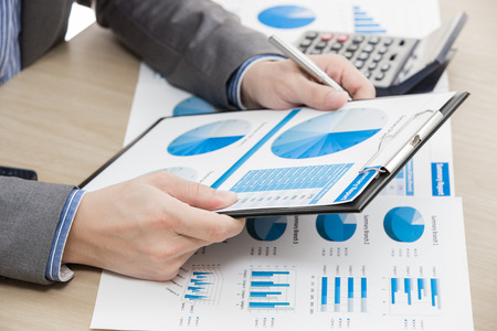business report and man hand with pen. Accountingの写真素材