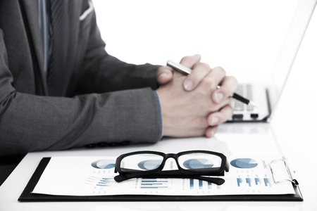 Businessman analyzing investment charts with laptop. Accountingの写真素材