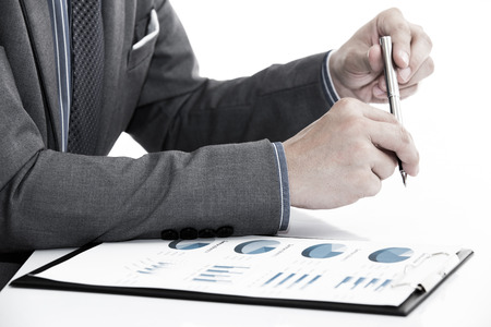 man hand with business report on tableの写真素材