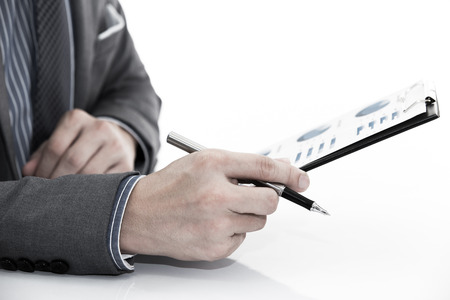 man hand with business report on tableの写真素材