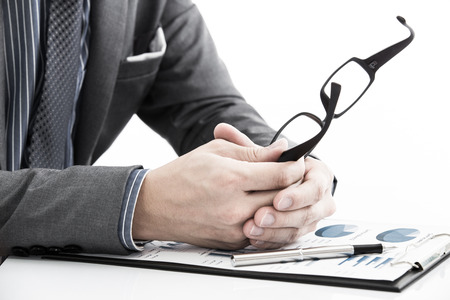 man hand with business report on tableの写真素材