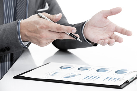 man hand with business report on tableの写真素材