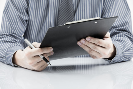 man hand with pen and business reportの写真素材