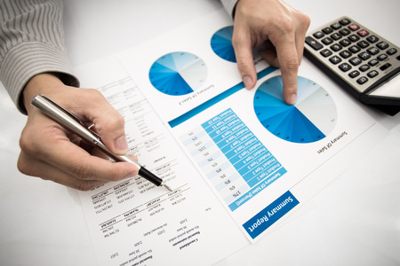 man hand with pen and business report. Accountingの写真素材