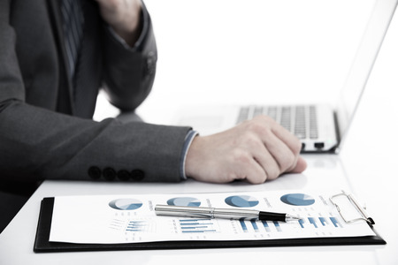 Businessman analyzing investment charts with laptop. Accountingの写真素材