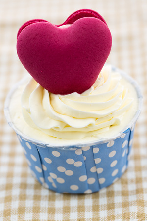 Tasty cupcake with butter cream on lights backgroundの写真素材