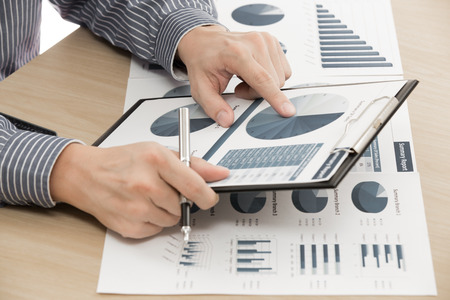 man hand with pen and business report. Accountingの写真素材