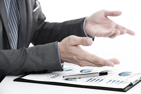 man hand with business report on tableの写真素材