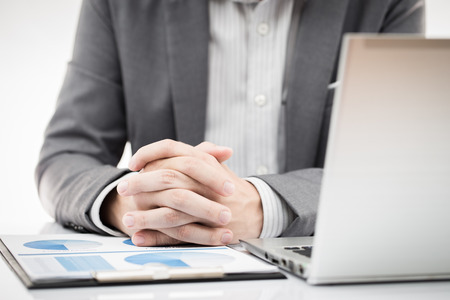 Businessman analyzing investment charts with laptop. Accountingの写真素材