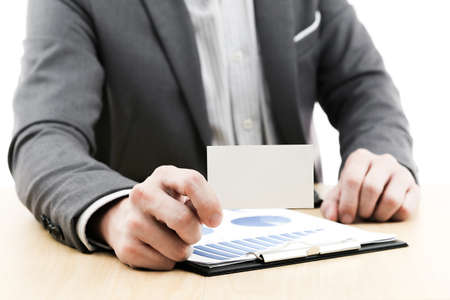Businessman showing blank business card on tableの写真素材