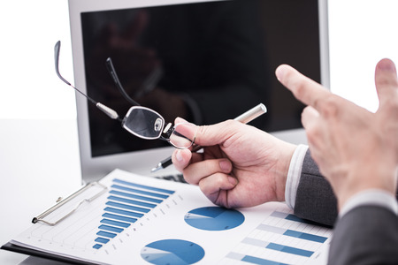 Businessman analyzing investment charts with laptop. Accountingの写真素材