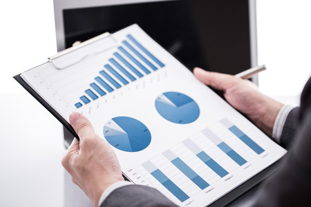 Businessman analyzing investment charts with laptop. Accountingの写真素材