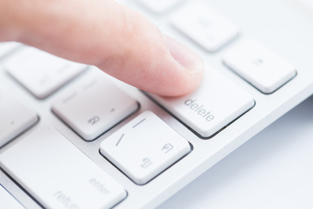 Close-up of man hand typing on keyboardの写真素材