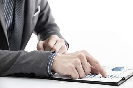 man hand with business report on tableの写真素材