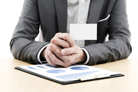 Businessman showing blank business card on tableの写真素材