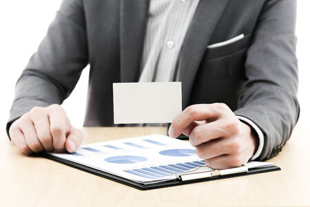 Businessman showing blank business card on tableの写真素材