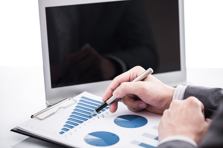 Businessman analyzing investment charts with laptop. Accountingの写真素材