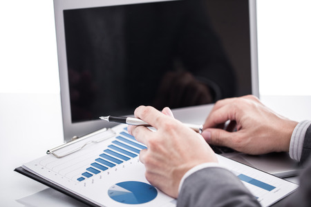 Businessman analyzing investment charts with laptop. Accountingの写真素材