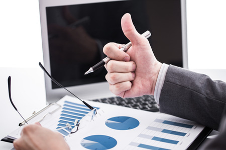Businessman analyzing investment charts with laptop. Accountingの写真素材