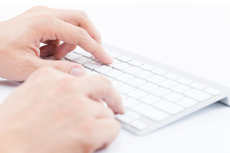 Close-up of man hand typing on keyboardの写真素材