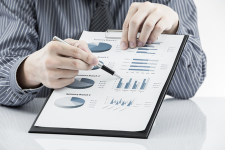man hand with pen and business reportの写真素材