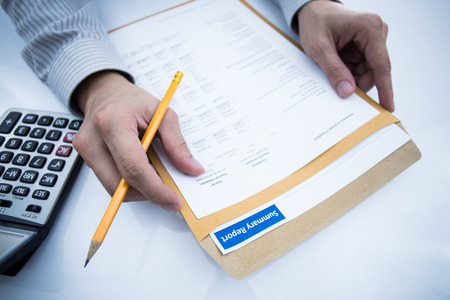 man hand with pen and business report. Accountingの写真素材