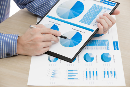 man hand with pen and business report. Accountingの写真素材