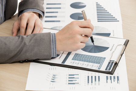 business report and man hand with pen. Accountingの写真素材