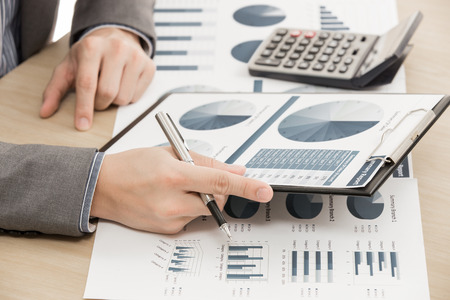 business report and man hand with pen. Accountingの写真素材