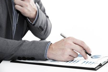 man hand with business report on tableの写真素材