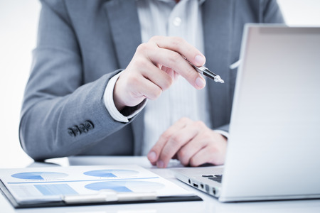 Businessman analyzing investment charts with laptop. Accountingの写真素材