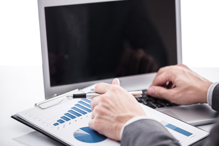 Businessman analyzing investment charts with laptop. Accountingの写真素材