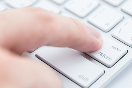Close-up of man hand typing on keyboardの写真素材
