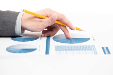 Businessman's hand showing financial report on tableの写真素材