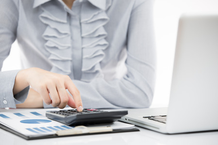 Business woman analyzing investment charts with laptop. Accountingの写真素材