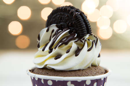 Tasty cupcake with butter cream on lights backgroundの写真素材