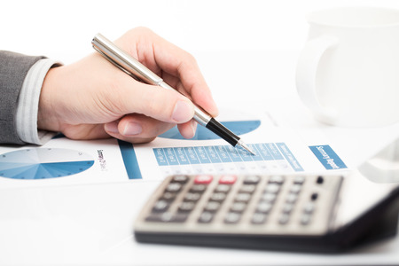 Businessman's hand showing financial report on tableの写真素材