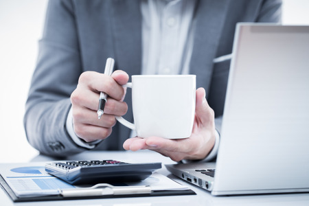 Businessman analyzing investment charts with laptop. Accountingの写真素材