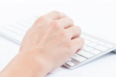 Close-up of man hand typing on keyboardの写真素材