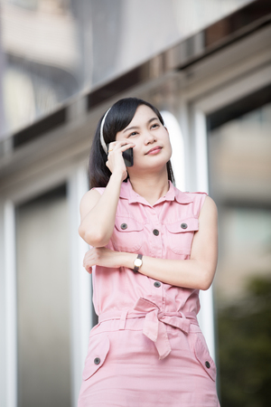 Asian Beautiful businesswoman using a cellular phoneの写真素材