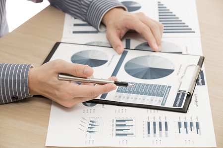 man hand with pen and business report. Accountingの写真素材