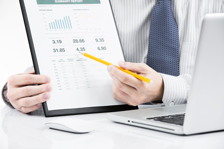 Businessman analyzing investment charts with laptop. Accountingの写真素材