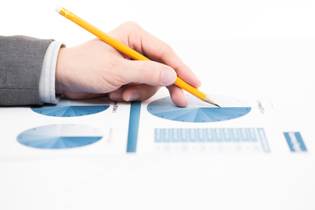 Businessman's hand showing financial report on tableの写真素材