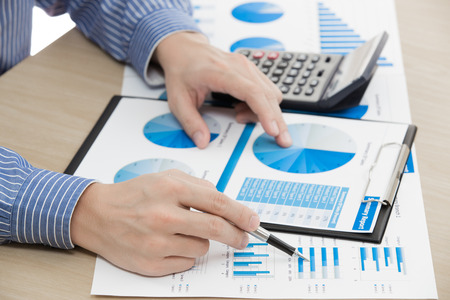 business report and man hand with pen. Accountingの写真素材