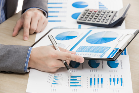 business report and man hand with pen. Accountingの写真素材