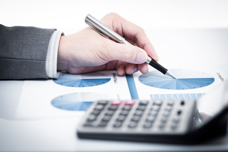 Businessman's hand showing financial report on tableの写真素材