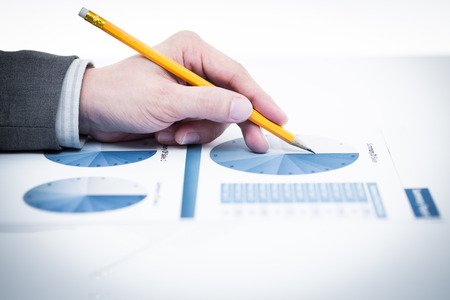 Businessman's hand showing financial report on tableの写真素材